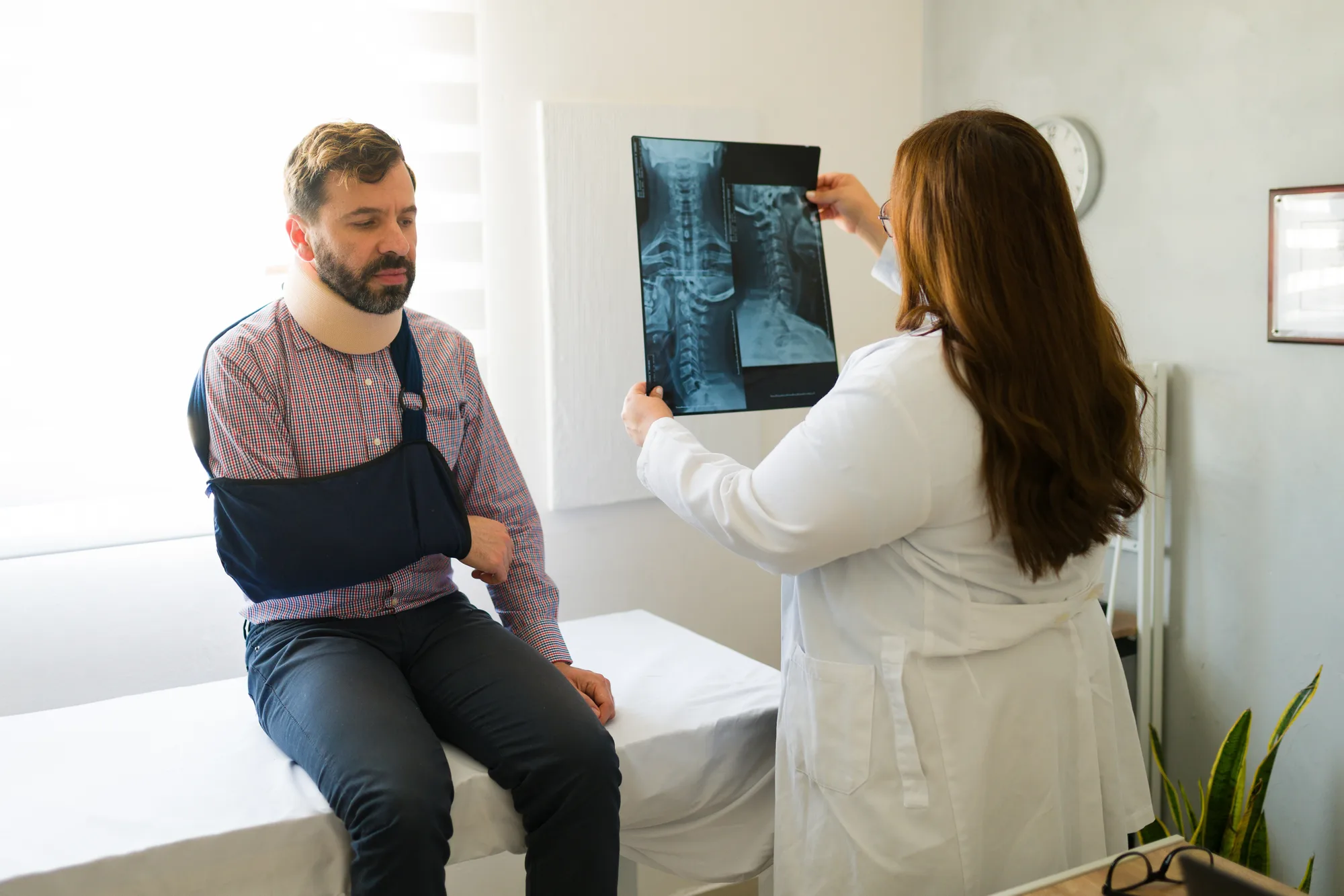 An injured man, who is consulting with a New Jersey physician about their Cervical Radiculopathy.