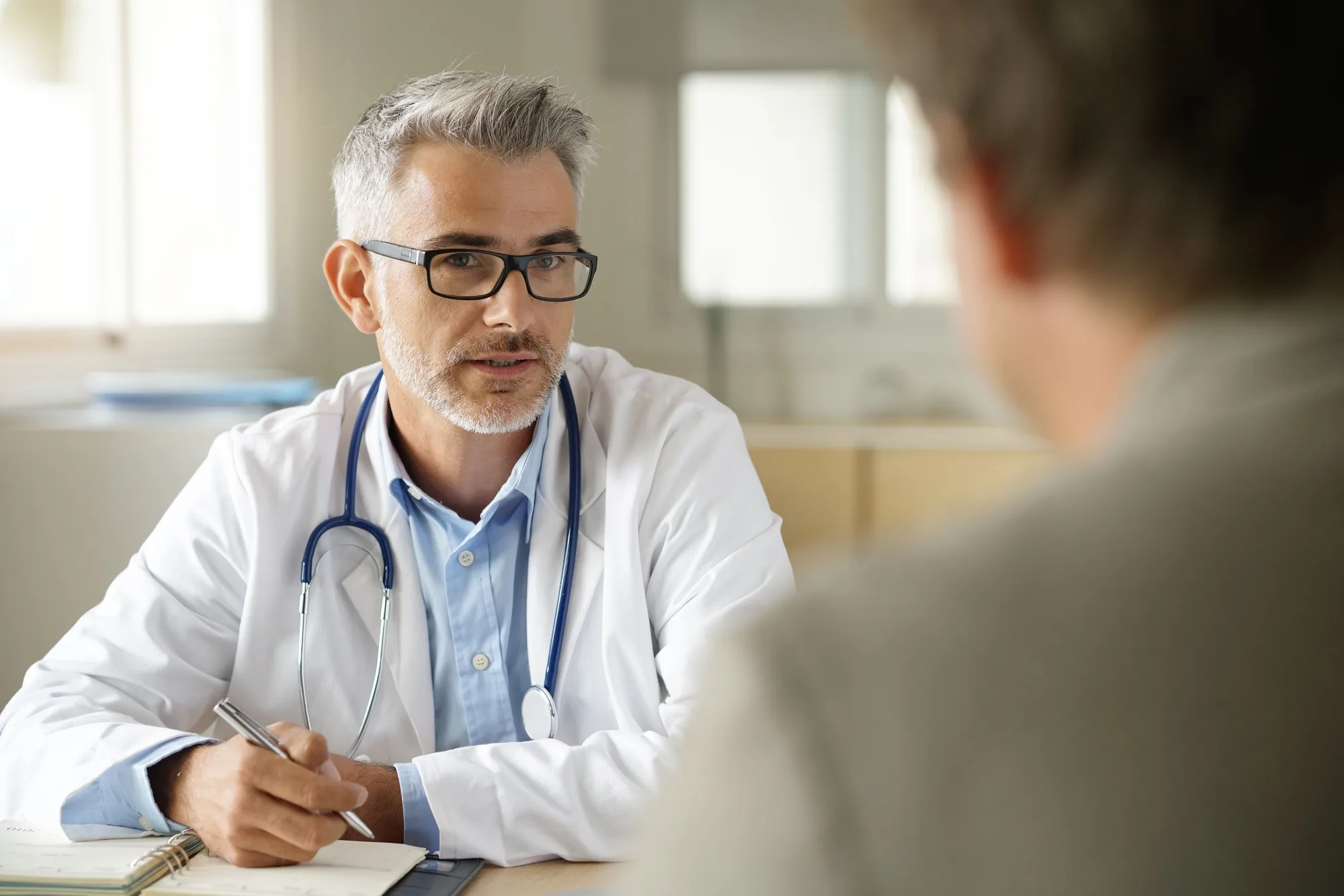 A New Jersey spine doctor consulting with a patient about their spinal conditions.