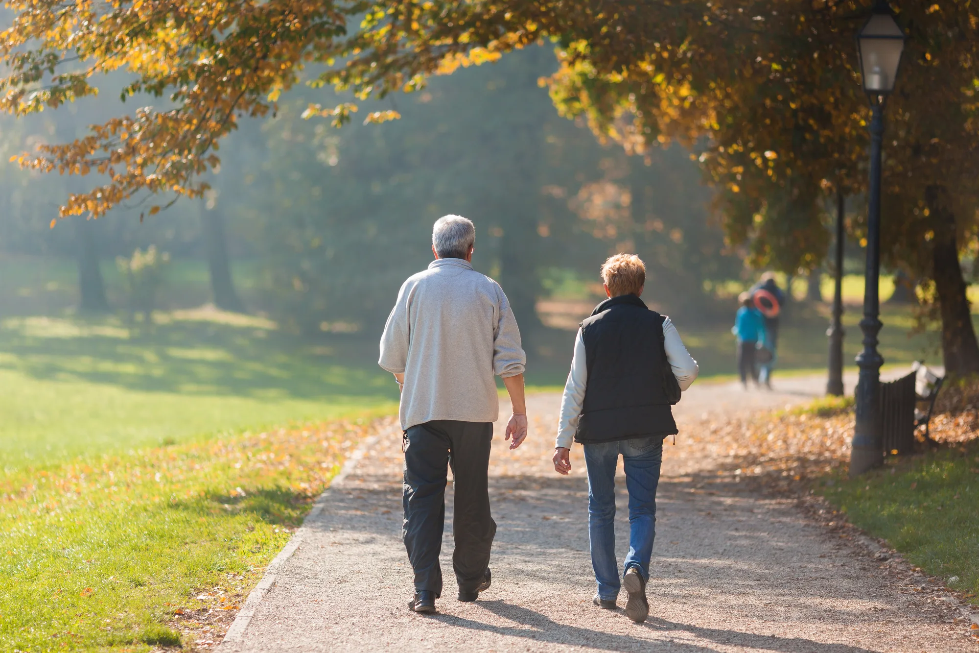 A New Jersey man and his wife enjoying a long walk after spinal surgery.