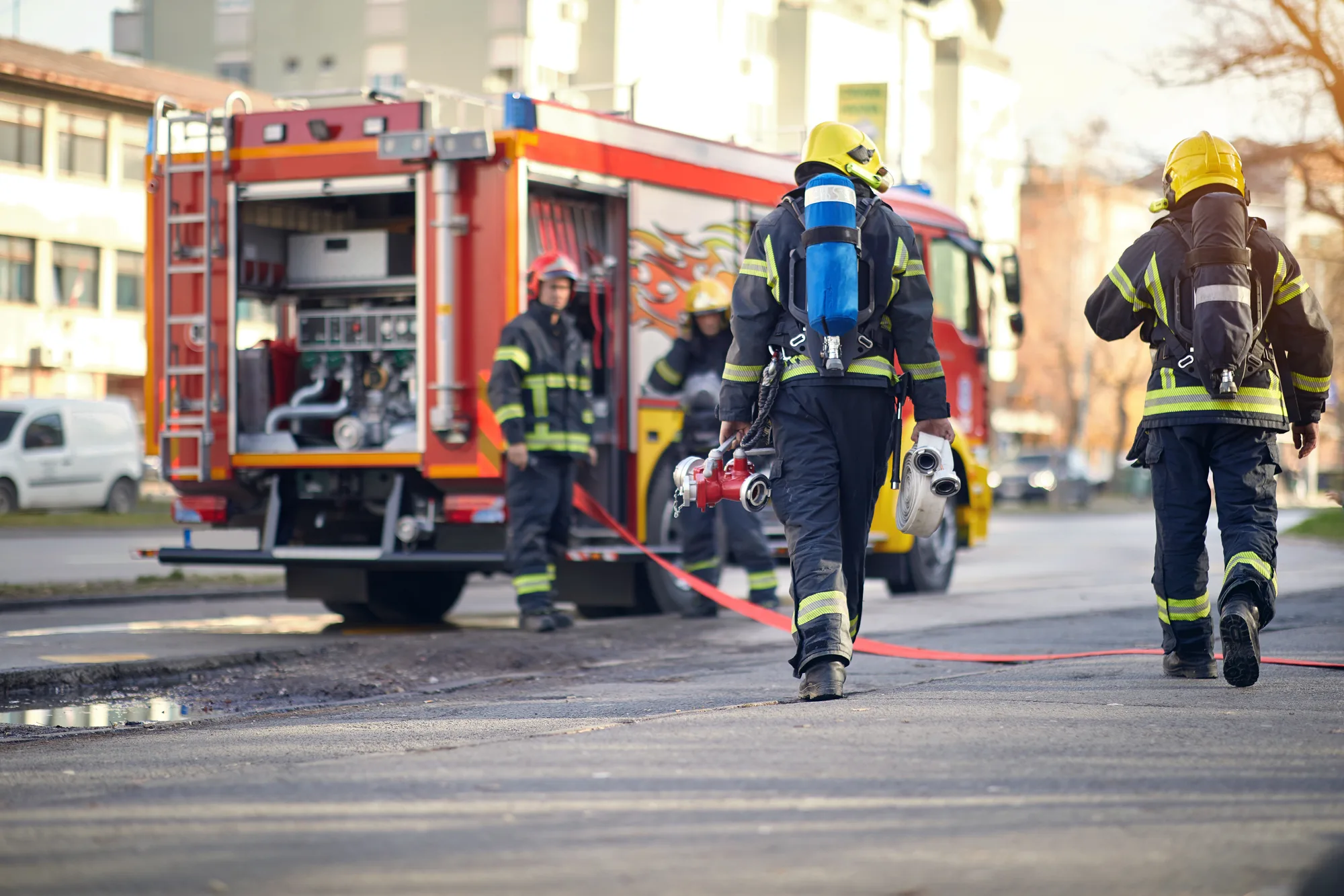 A New Jersey firefighter, wearing all of their gear and running back to the fire truck