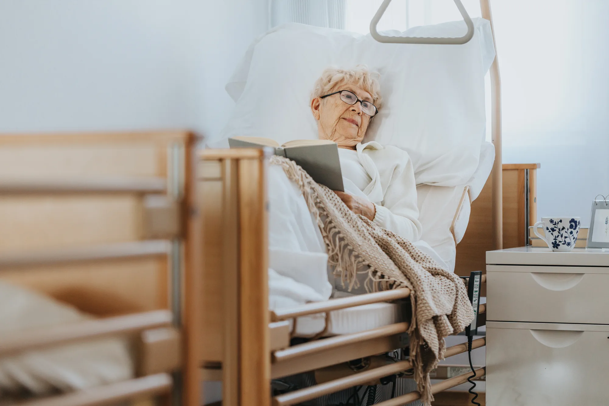 Older New Jersey woman in bed after spine surgery.
