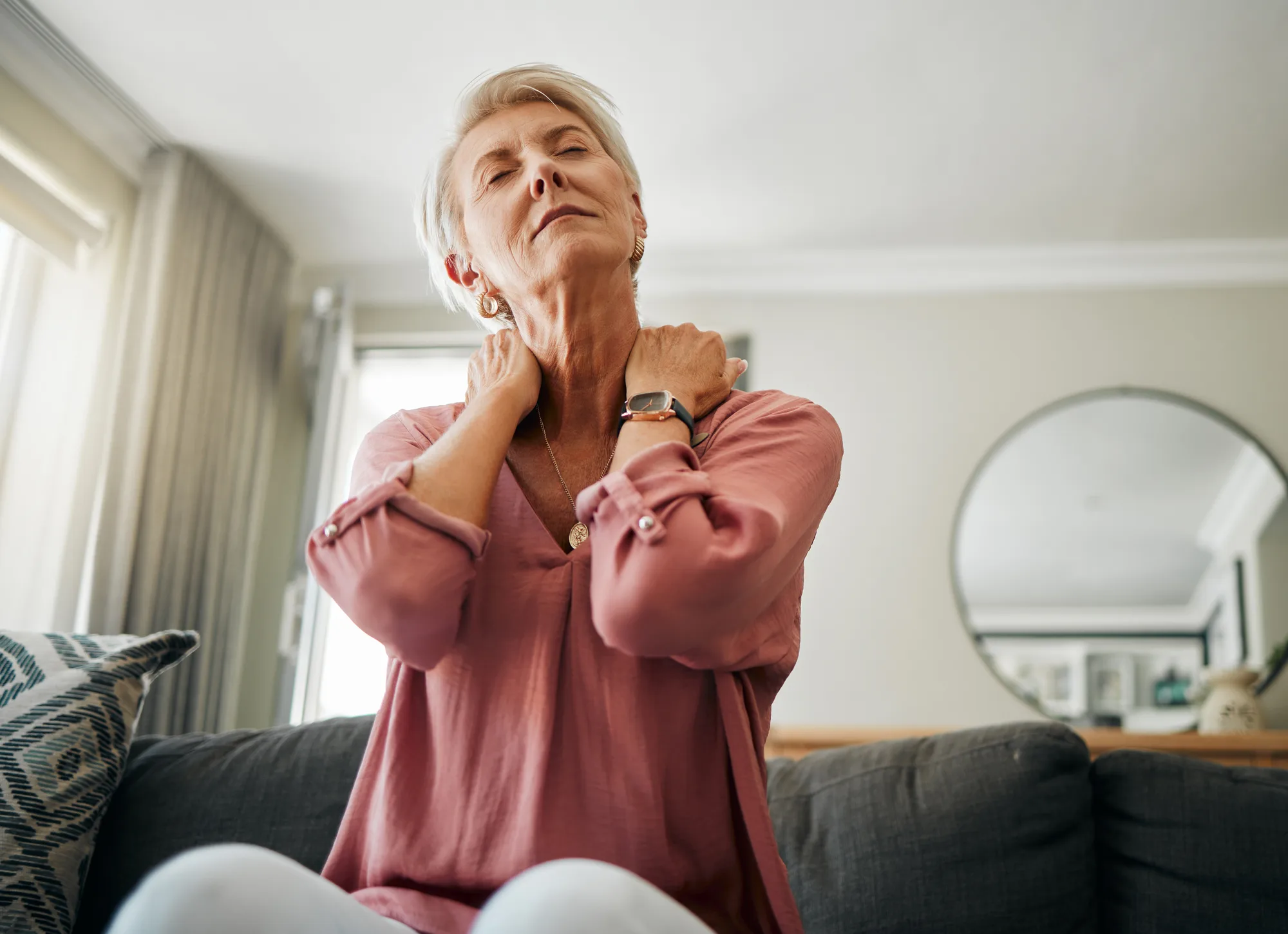 An elderly woman from New Jersey experiencing pain in her neck due to some sort of spinal condition.