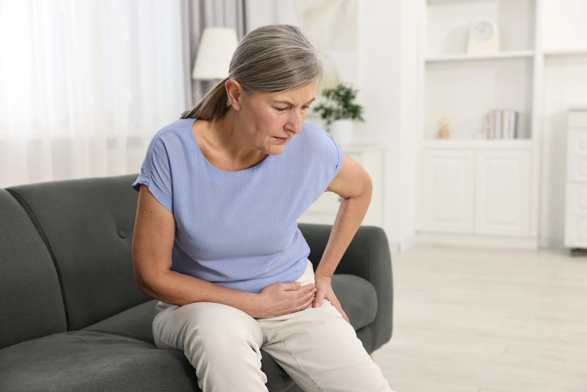 An older New Jersey woman experiencing pain and balance issues due to spinal compression.
