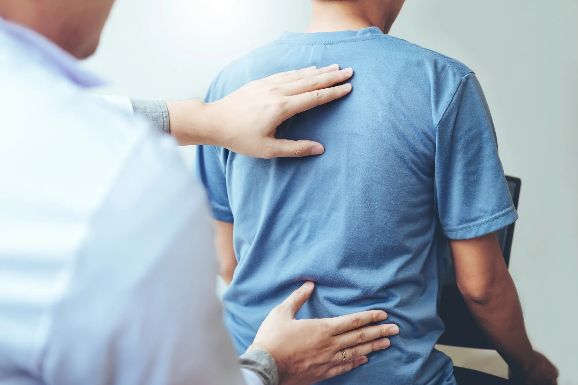 New Jersey spine doctor evaluating a patient's back and neck.