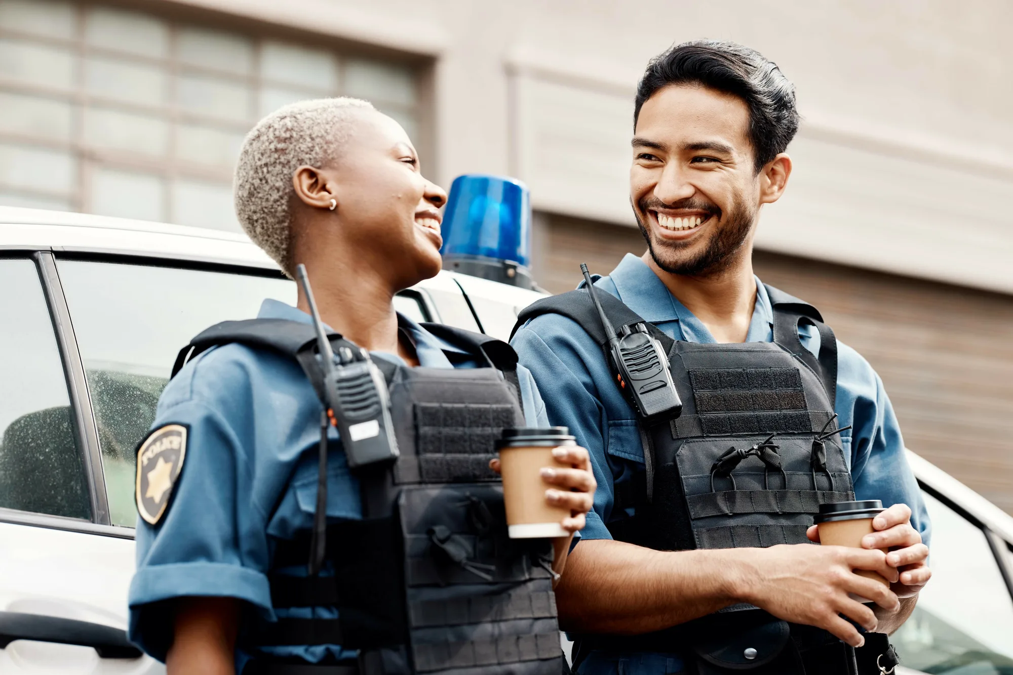 Two New Jersey police officers enjoying a coffee together before their shift.