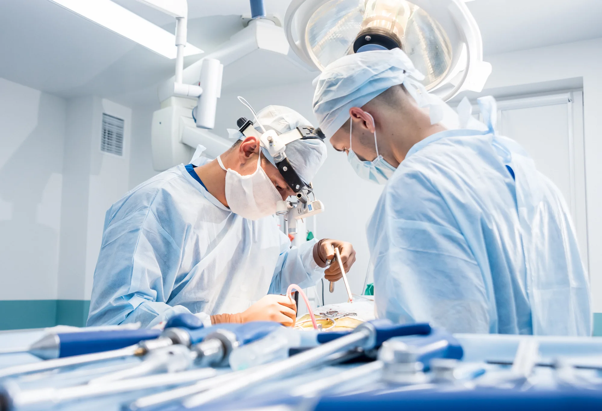 Two New Jersey surgeons working on a spinal patient.