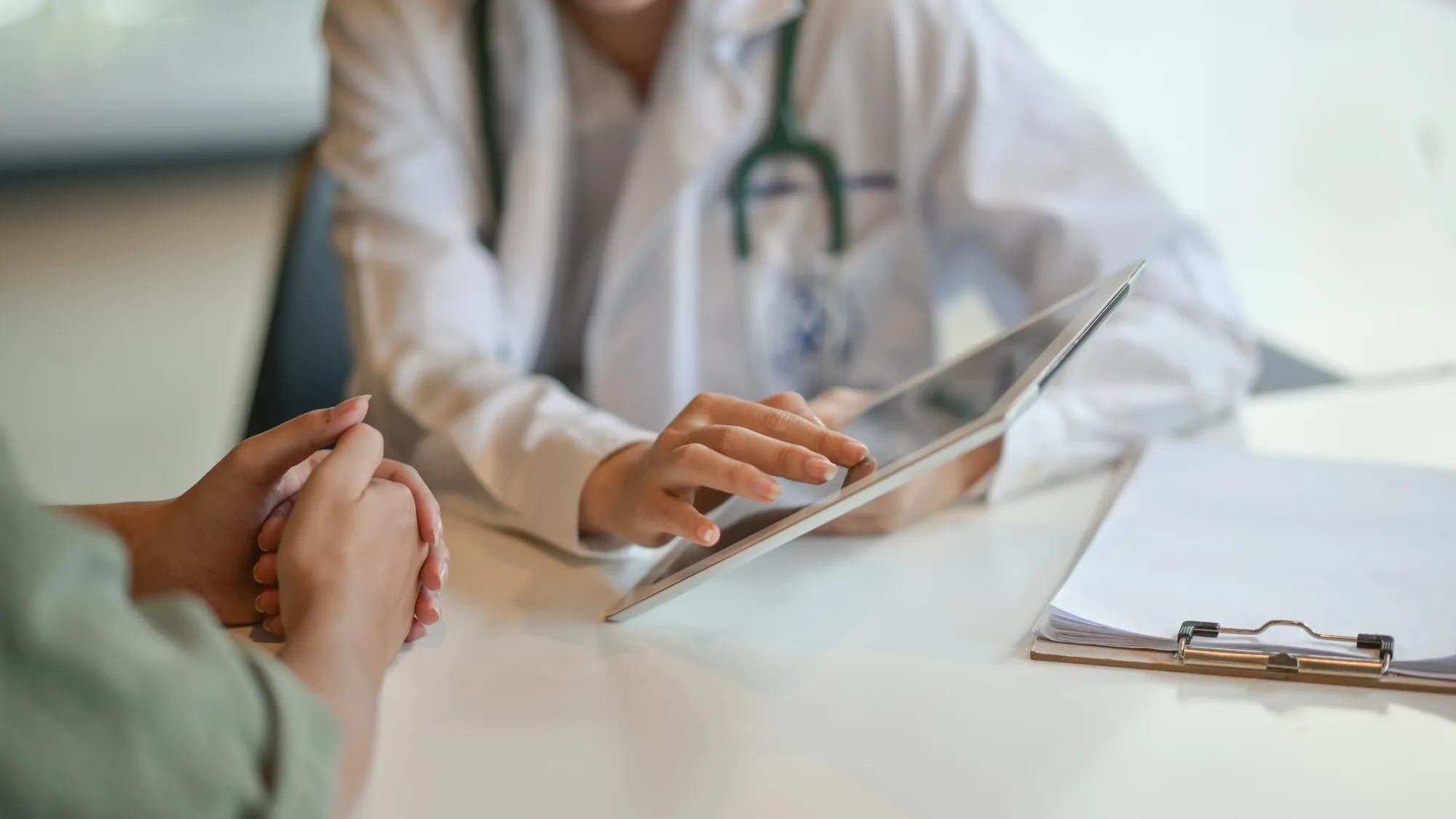 A New Jersey spinal surgeon consulting with a patient prior to their procedure.