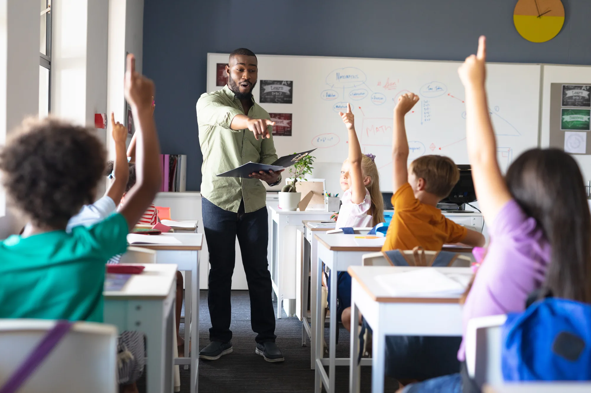 A New Jersey teacher standing all day in class, coping with a spinal issue.
