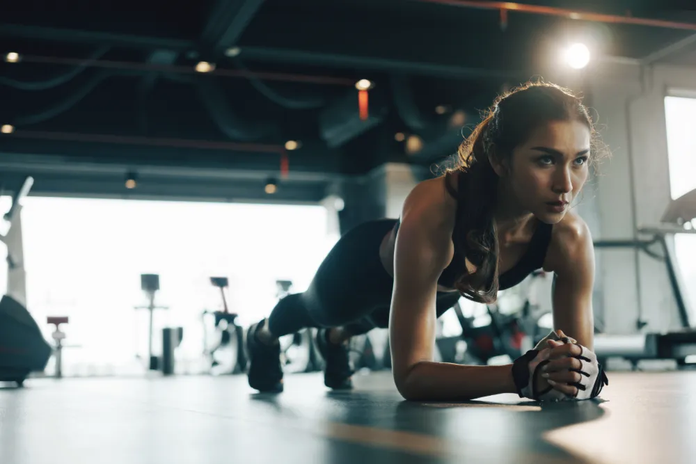 Young NJ woman doing planks to improve her lumbar spine strength.